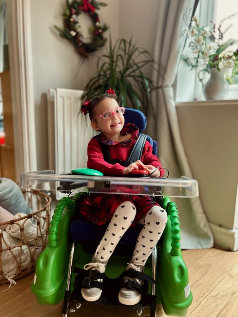 Child in her brilliant Bugzi powered chair